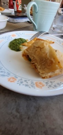 Outcome is a fried samosa being enjoyed with homemade mint chutney